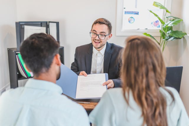 lawyer reviewing agreement with clients