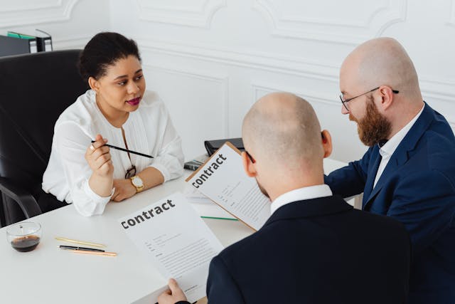 two men reviewing a contract with a third party