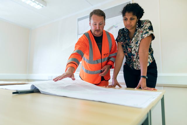 two people looking over construction plans